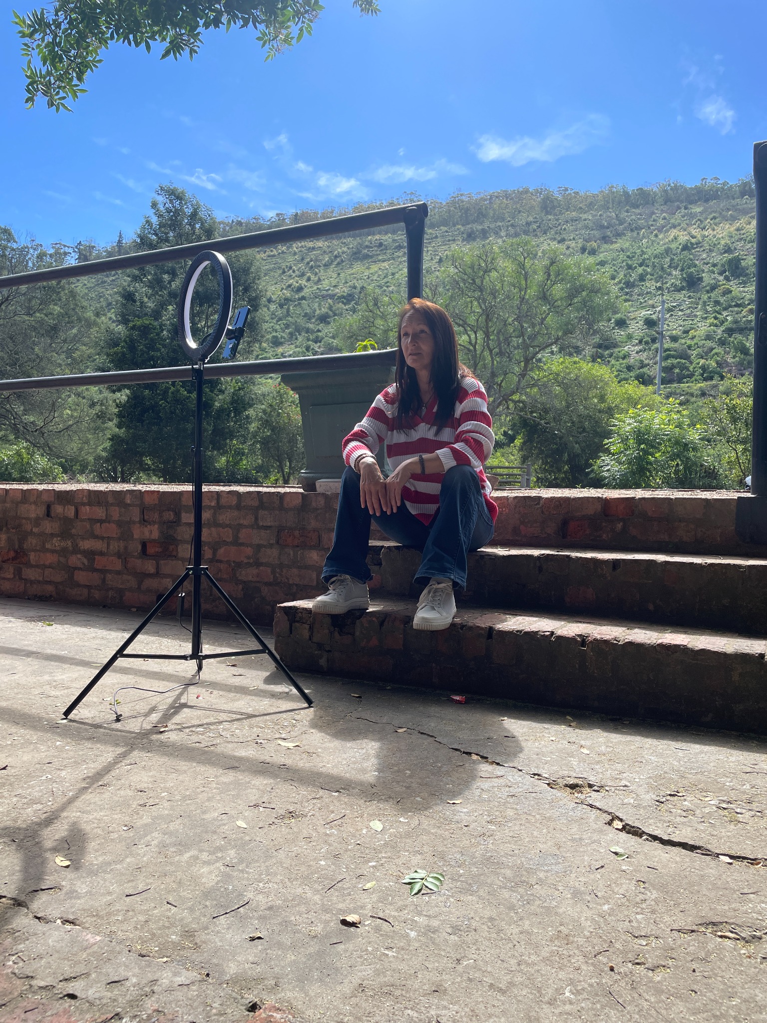 Tracey sitting on brick steps outdoors